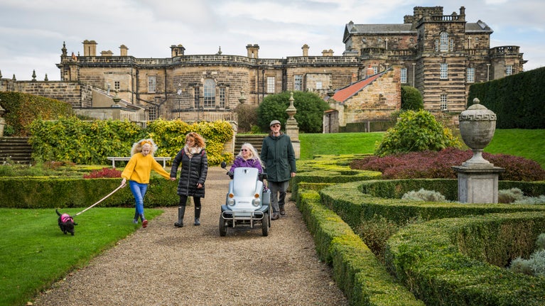 Visitors to the Parterre garden in autumn at Seaton Delaval Hall Northumberland